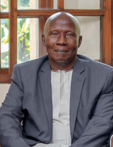 Headshot of Ssalongo Francis Drake Mugerwa, seated 